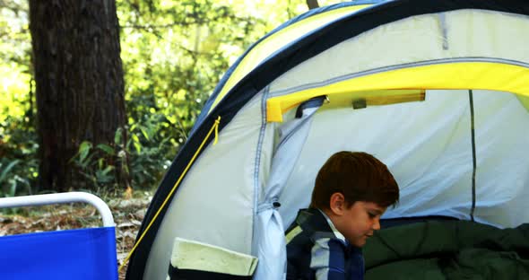 Boy playing cards in the tent