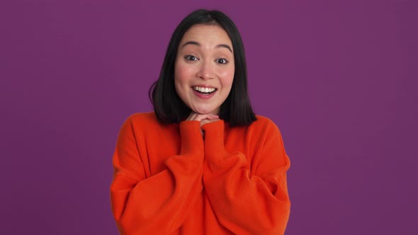 Cute woman in red sweater looking at the camera