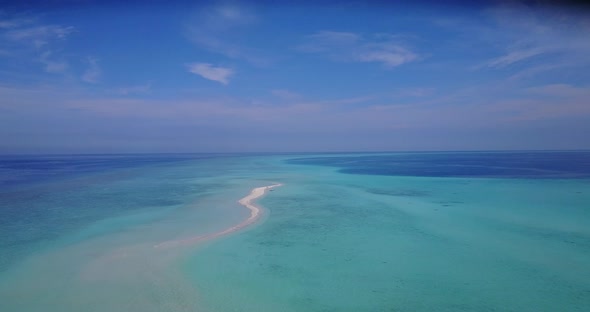 Wide angle birds eye island view of a white paradise beach and aqua blue ocean background in hi res 