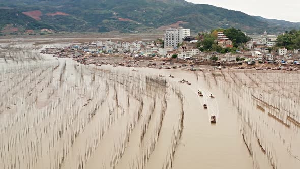 Aerial shot of fishermen heading out to sea on the coast of China