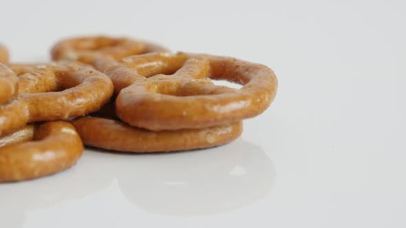 Pretzel snack close-up on white background 4K 2160p 30fps UltraHD tilting footage - Baked bread prod