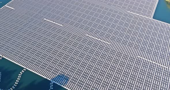 Aerial View of Solar Systems Panels Floating on Open Water Pond Alternative to Renewable Energy