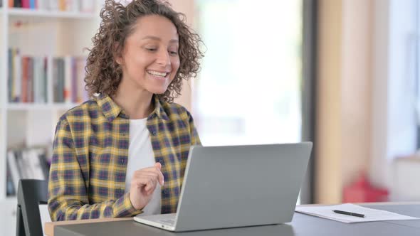 Online Video Chat on Laptop By Young Mixed Race Woman at Work 