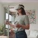 Young woman enjoying virtual reality experience with goggles and handle control - VideoHive Item for Sale