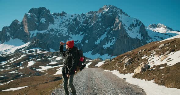 Inspired Solo Traveler Man Walk on Empty Countryside Road Overlooking Landscape