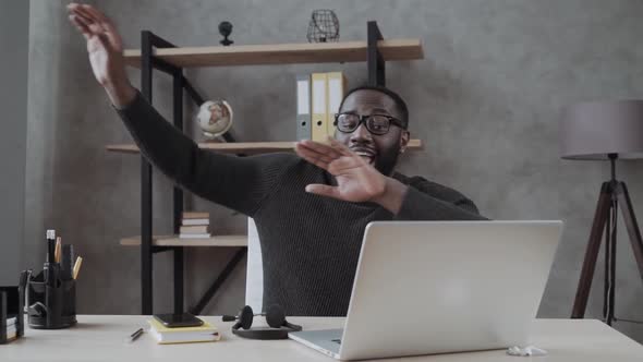 Black Guy Funny Dancing with Joy at the Desktop with a Laptop