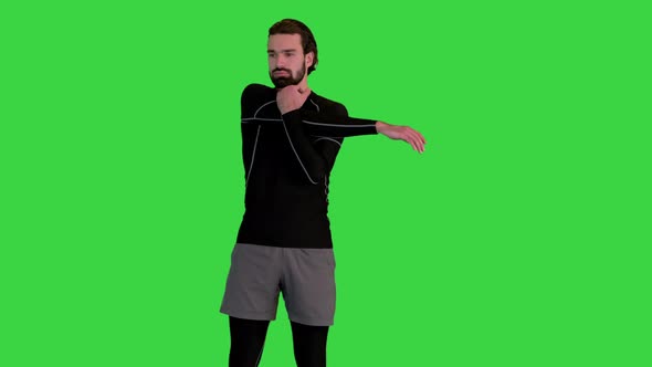 Sporty Fitness Man Warming Up on a Green Screen Chroma Key