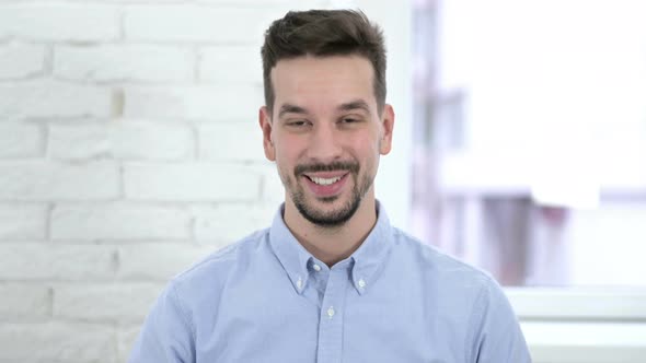 Portrait of Creative Man Shaking Head To Accept Offer