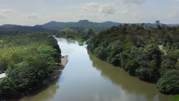 Aerial Drone View of Rainforest River and Mountains Scenery in Costa Rica at Boca Tapada, San Carlos