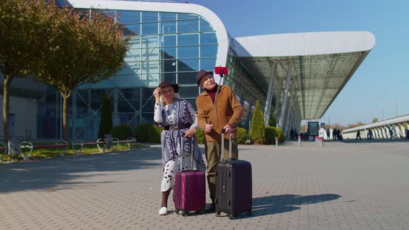 Senior Pensioner Tourists Grandmother Grandfather Using Mobile Phone Make Selfie Vlog Near Airport