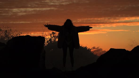 Silhouettes Girls Jumping Hold Hands. Beautiful Two Females Circling. Against Light Running