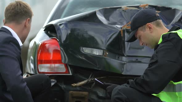 Police Inspector Filling Car Accident Report Analyzing Damage Stressed Driver