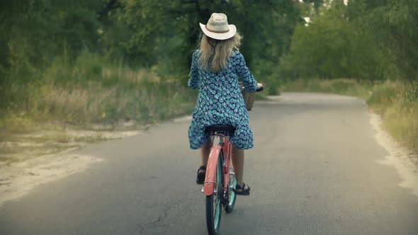 Woman Hair Fluttering.Cyclist Girl Wearing Dress Workout.Cyclist Woman On Bicycle.