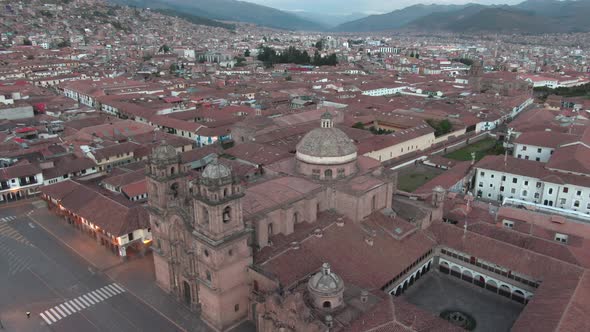 4k daytime aerial drone footage with the Church of the Society of Jesus from Plaza de Armas in Cusco