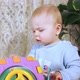 Concentrated Baby Sits at Home and Plays with Developing Cube - VideoHive Item for Sale