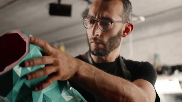 Close-up: pattern vase in the hands of a sculptor artisan artist in the workshop