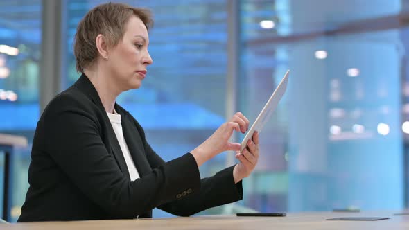 Old Businesswoman Typing Email on Tablet