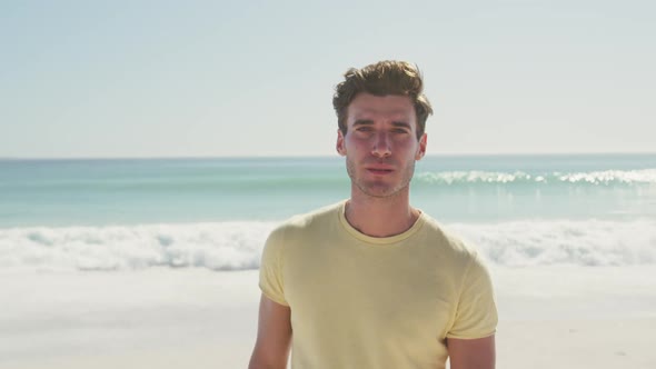Caucasian man looking at the camera at beach