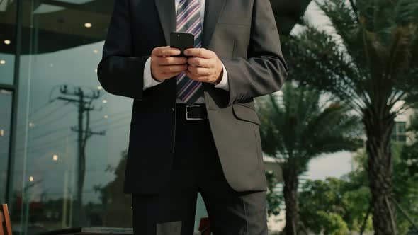 Male Reading Phone Message or Downloading an App for His Mobile Phone