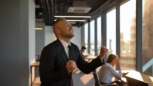 Entrepreneur Dance By Window in the Office During Sunset