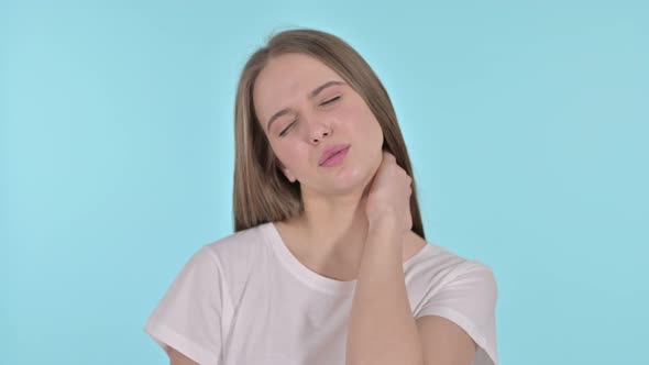 Tired Beautiful Young Woman Having Neck Pain, Blue Background