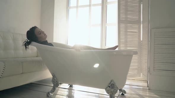 Nice Model with Dark Hair Poses in Stylish Vintage Bath