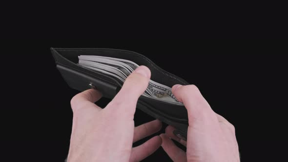 Male Hands Show a Black Wallet Full of 100 Dollar Bills on Alpha Channel