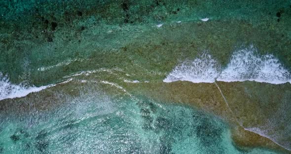 Wide aerial tourism shot of a summer white paradise sand beach and blue sea background in hi res 4K