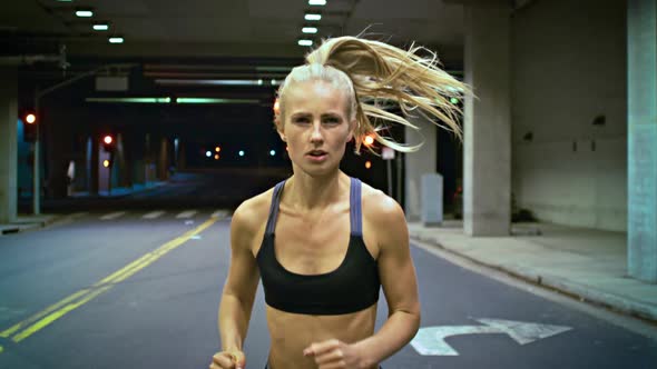 Attractive Woman Jogging Through A Tunnel