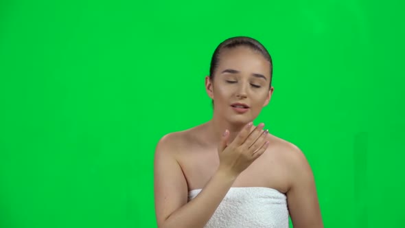 Woman in a White Towel Examines Her Face and Problem Skin, Points Her Finger at the Problem Areas