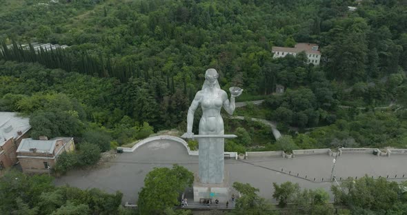 Aerial shot of the Mother of Georgia monument during a cloudy day in Tbilisi.
