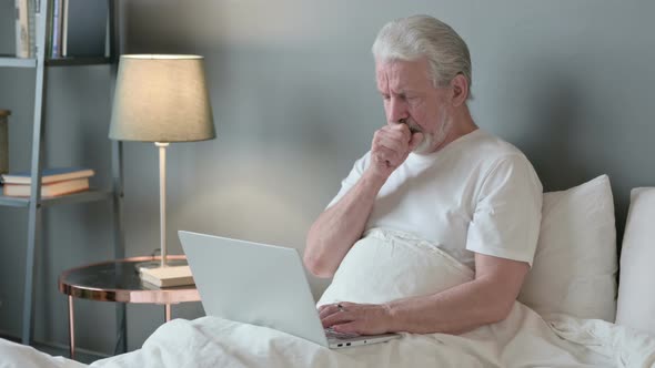 Old Man with Laptop Coughing in Bed 