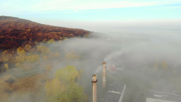 View of the Plant and the Pipes Covered with Morning Fog. Flight Over the City of Lviv in Ukraine