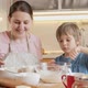 Happy Mother with Little Son Stirring and Mixing Dough Ingredients in Big Glass Bowl - VideoHive Item for Sale