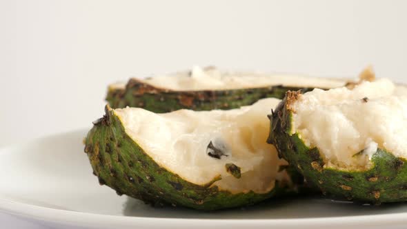 Closeup of Green Sliced Soursop Graviola, Exotic, Tropical Fruit Guanabana on Plate
