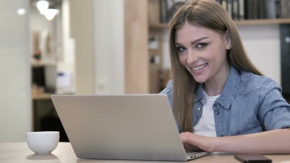 Happy Creative Young Girl Winking Eye While Looking at Camera