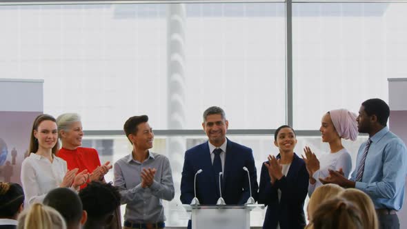 Businessman standing on the podium with his colleagues in the business seminar 4k