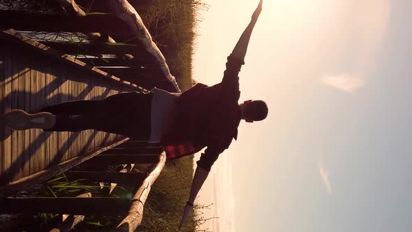 Vertical Video boy running on wooden bridge