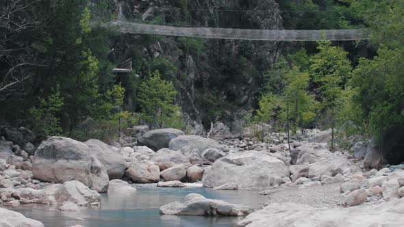 Lake in the Mountains and a Rope Bridge