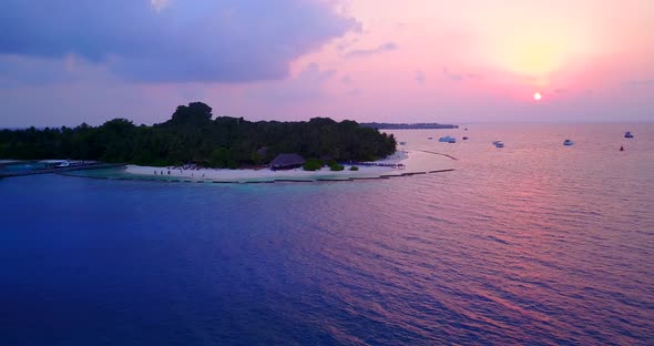 Tropical overhead tourism shot of a paradise sunny white sand beach and blue sea background in color