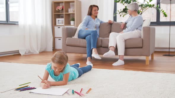 Adults Talking and Girl Drawing at Home 