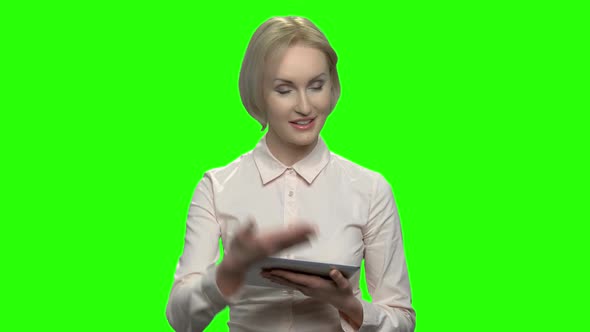 Businesswoman Using Electronic Tablet and Talking