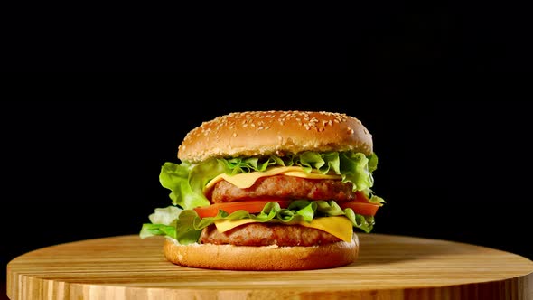 Cheeseburger with Bacon on a Dark Background. Close-up. Macro Shooting