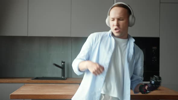 Amazed guy with artificial high tech hand prothesis pretends playing instruments