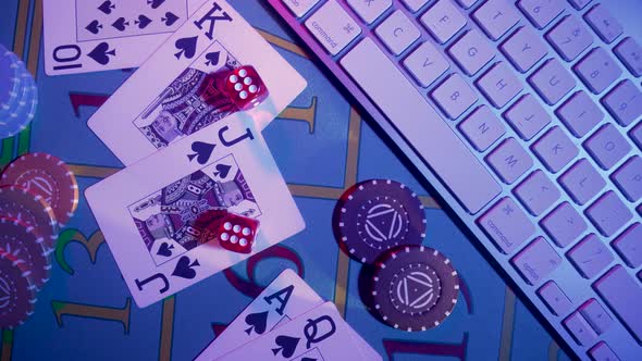 Top View of Gaming Table with Computer Keyboard Cards Dice and Casino Chips