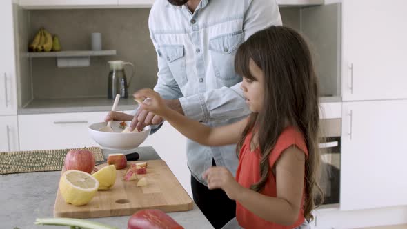 Dad Enjoying Cooking Dinner with Little Daughter