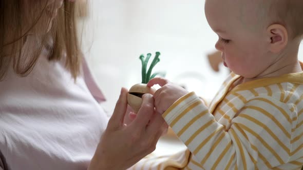 Little Baby Girl and Mommy Playing Wooden Eco Toys at Home