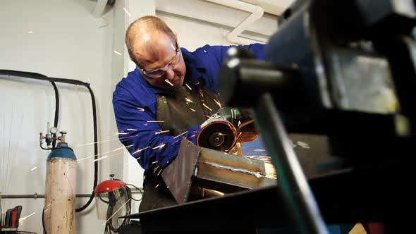 Welder working at work shop