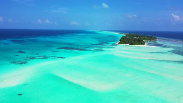 Daytime overhead abstract view of a sandy white paradise beach and aqua blue water background