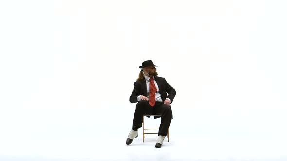 Elegant Man in a Black Hat Is Dancing an Erotic Dance. He Uses a Chair and a Cigarette. White